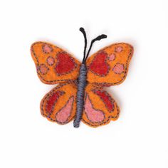 an orange and pink butterfly on a white background