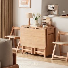 a living room scene with focus on the desk and chair, coffee maker in the corner