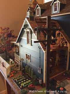 a doll house with lots of furniture and decorations on the front porch is shown in this image