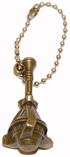 an antique brass bell is hanging from a chain