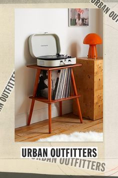 an old record player sitting on top of a table next to a shelf with records