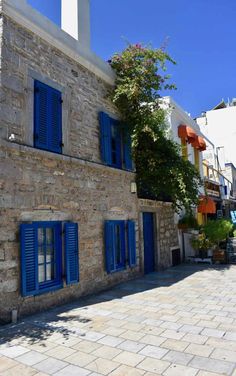 an old stone building with blue shutters