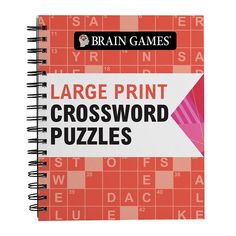 the large print crossword puzzles book is open to reveal an orange and pink cover