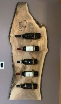 a wall mounted wine rack with six bottles