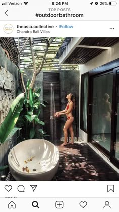 a woman in a bathing suit standing next to a bathtub