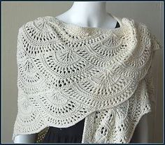 a white crocheted shawl on a mannequin