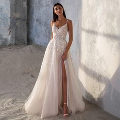 a woman in a wedding dress posing for the camera with her leg up on the floor