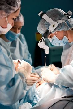 two doctors performing surgery on a patient