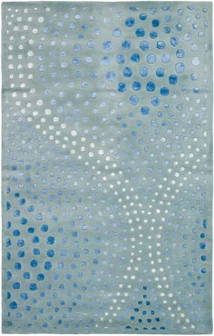 a rug with blue and white dots on it, in the shape of an abstract design