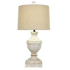 a white table lamp with a beige shade