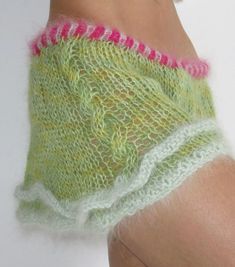 a woman's leg with green and pink knitted shorts