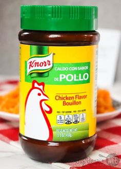 a jar of chicken flavor bouilon sitting on a red and white checkered table cloth