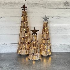 two wine cork christmas trees with lights on them