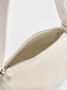 This product is made with at least 20% sustainable materials by weight. CHARLES & KEITH uses recycled, degradable, organic, and water-based materials in our eco-conscious collection. Balancing style with functionality, the Lumen crossbody bag will be a nifty addition to your wardrobe. While the exterior is kept minimalist, the padded texture and tasteful folds add subtle visual interest. With its clean cream finish, it will brighten up your outfits with a charming tactility. Equipped with an adjustable strap, you can opt to sling it on the shoulder or across the body. Cute Shoulder Bag, Pretty Bags, Charles Keith, Eco Conscious, Sustainable Materials, Kids Gifts, Bag Straps, Sales Gifts, Trending Shoes