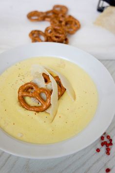 a white bowl filled with soup and pretzels