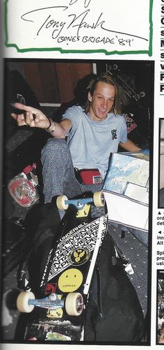 a man sitting on the floor with his skateboard