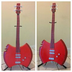 a red guitar shaped like a cat sitting on top of a stand next to a wall