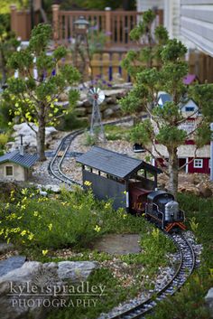 a model train set is shown with trees and buildings