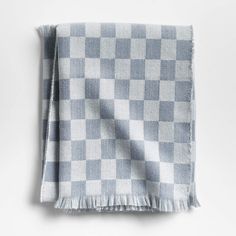 a blue and white checkered blanket with fringes