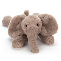 an elephant stuffed animal laying on the ground