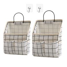 two white and black baskets with hooks on them