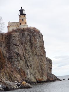 a light house sitting on top of a cliff