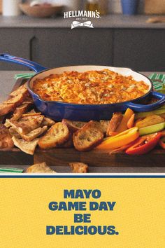 an advertisement for a game day is displayed on a table with bread and veggies