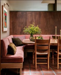 a dining room table with chairs and a bench