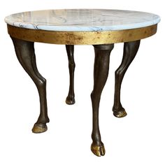 a table with marble top and gold legs