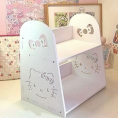 a white children's desk with hello kitty cutouts on the top and bottom