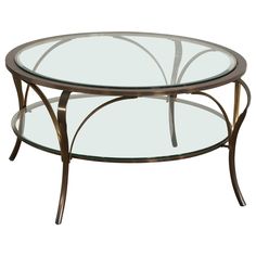 an oval glass coffee table with metal frame and curved legs, on a white background