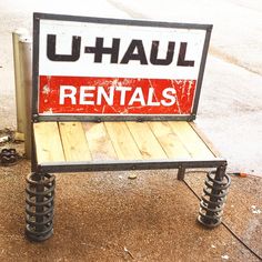 a rental sign sitting on top of a wooden bench