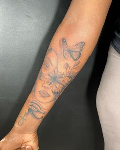 a woman with a butterfly tattoo on her arm