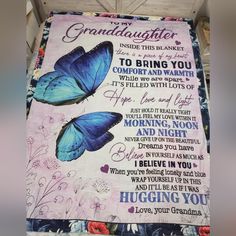 a blue butterfly blanket with the words granddaughter on it