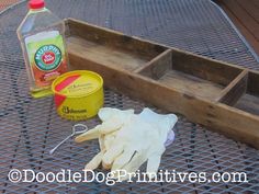 gloves and cleaning supplies sitting on top of a metal table next to a bottle of cleaner