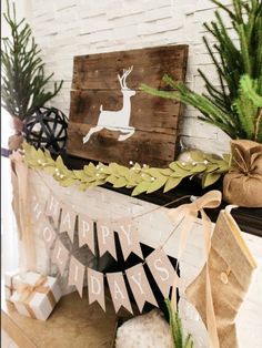 a fireplace mantel decorated for christmas with stockings and presents on it, along with a deer sign