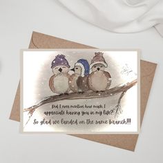 three birds sitting on a branch with a card