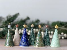 small ceramic christmas trees lined up on a table