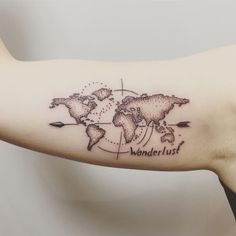 a woman's arm with a world map tattoo on it, which reads wonder just