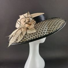 "Stunning extra wide brim Audrey Hebburn hat for Kentucky derby or Royal Ascot, made of high quality cream sinamey. The crown is 2\" (5 cm) high and it stays on the top of your head. It is secured with elastic that goes under your hair. The brim is covered with an astonishing black cotton lace and the hat is decorated with natural color sinamey flower. The wide from 5.5\" to 6\" (14 to 15 cm) brim make it really special and suits almost all face types. The hat is hand blocked on a wooden block and hand stitched to perfection at Irina Sardareva millinery atelier. It is great to wear on Derby races, Royal Ascot, Cocktail parties, Weddings, Tea parties, etc. This hat is available is with low crown and fitting is secured by elastic. It fits all head sizes. We deliver by Priority mail service. Short Brim Hat For Evening Royal Ascot, Elegant Party Hat With Curved Brim, Wide Brim Sinamay Boater Hat For Evening, Chic Evening Cloche Costume Hat, Elegant Curved Brim Party Hat, High Crown Mini Hats For Royal Ascot Evening, Chic Party Hat For Royal Ascot, Classic Short Brim Top Hat For Spring Evenings, Elegant Costume Hat With Curved Brim For Evening