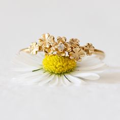 a close up of a flower on top of a white surface with a yellow center