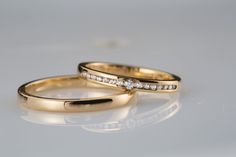 two yellow gold wedding rings with diamonds on white background photo - free image about jewelry