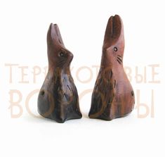 two wooden rabbits sitting next to each other