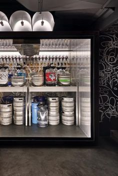 the inside of a store with cans and buckets in it's display case