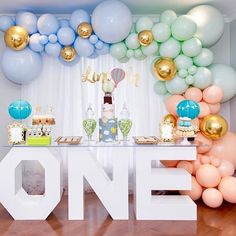 balloons and balloons are on display at a birthday party with the word one above it