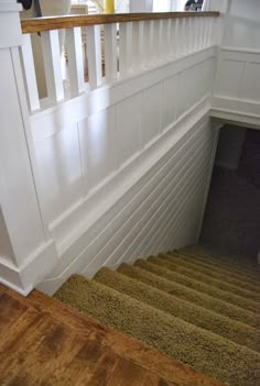 the stairs are made of wood and have carpet on them