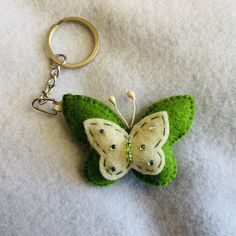 a keychain with a green and white butterfly on it