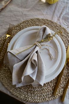 a place setting with napkins and goldware