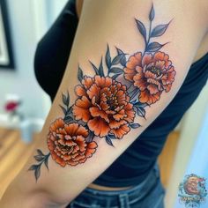 a woman's arm with orange flowers on it