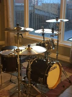 a drum set sitting in front of a window